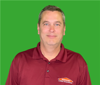 Employee on green screen with red shirt and green hair 